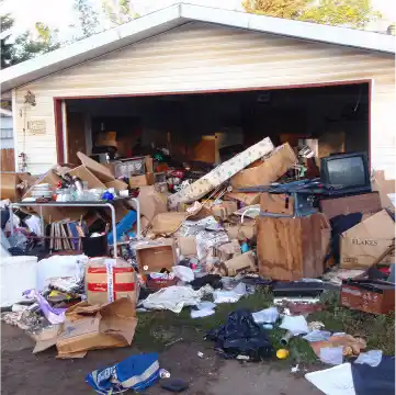 Cluttered garage before Junk Amigos junk removal.