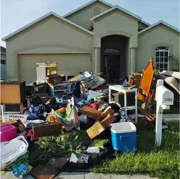 Pile of household junk on the lawn awaiting removal.