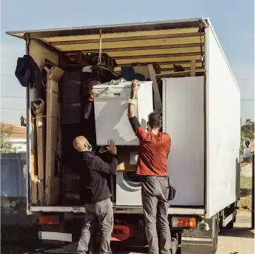 Refrigerator removal by employees of Junk Amigos Charlotte.