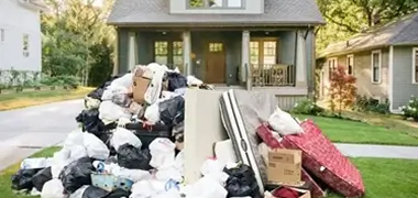 Pile of household junk on the lawn awaiting removal.