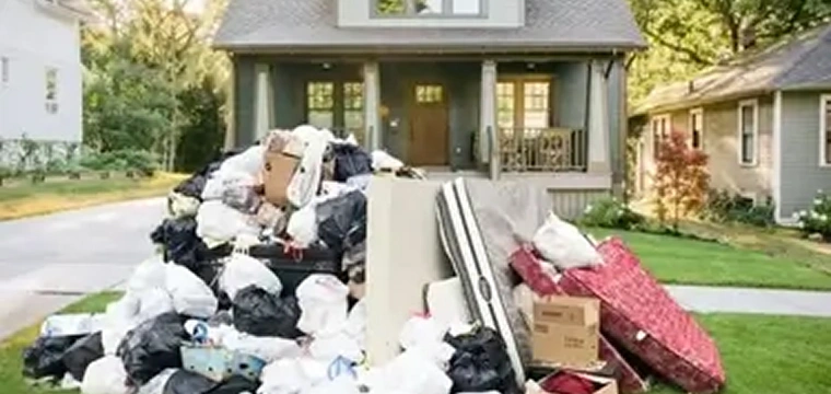 Pile of household junk on the lawn awaiting removal.